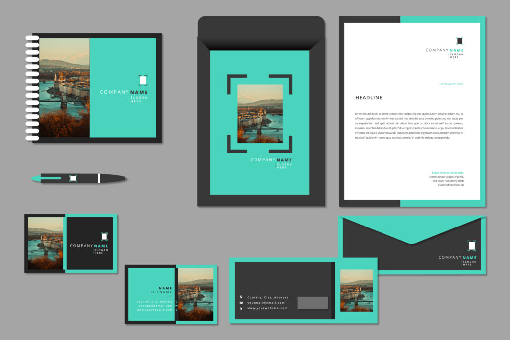 Corporate identity stationery mockup featuring a turquoise and charcoal gray layout with a cityscape photo